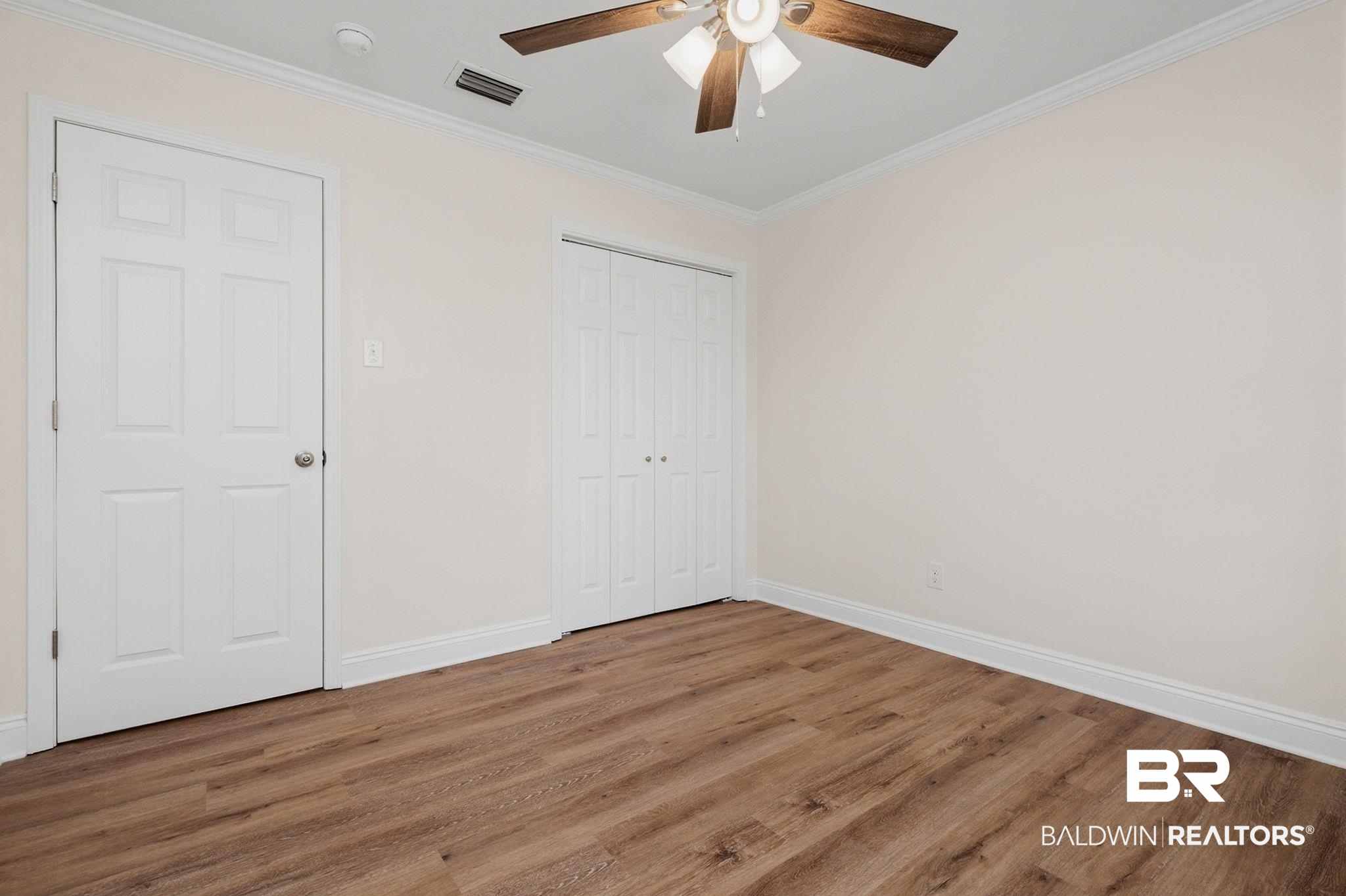 814 Nassau Drive Mobile, AL 36608 - Photo 22 of 44 Unfurnished bedroom with ornamental molding, wood finished floors, a closet, and ceiling fan