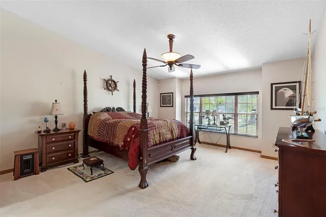 a bedroom with bed and a chandelier