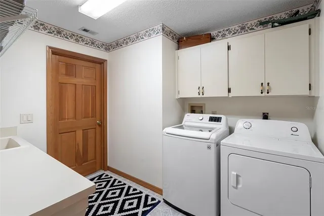 a view of storage and utility room with a washer dryer