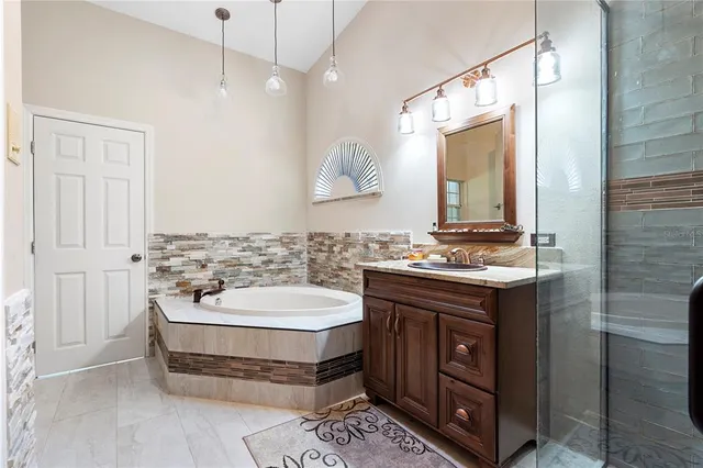 a bathroom with a double vanity sink a mirror and a bathtub