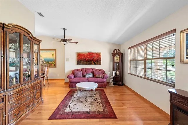 a living room with furniture and a floor to ceiling window
