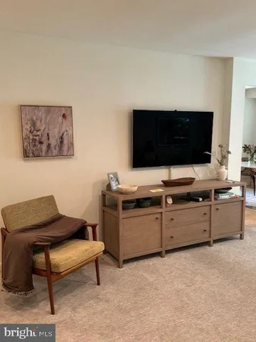 a bedroom with a bed and a television