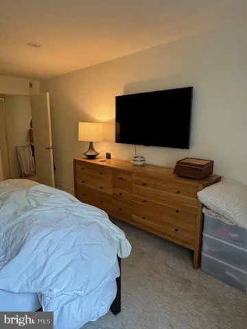 a bedroom with a bed and lamp