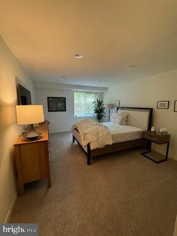 a bedroom with a bed and a table