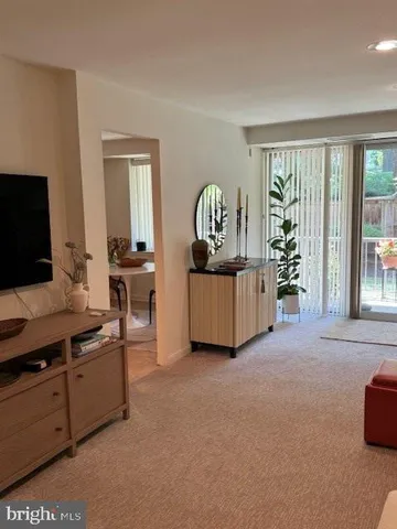 a living room with furniture and a lamp