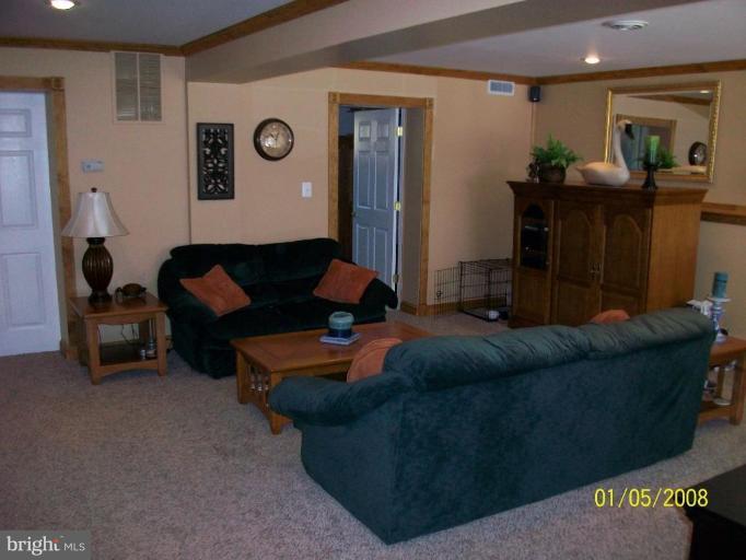 1202 Robin Court Halethorpe, MD 21227 - Photo 2 of 18 a living room with furniture and a clock