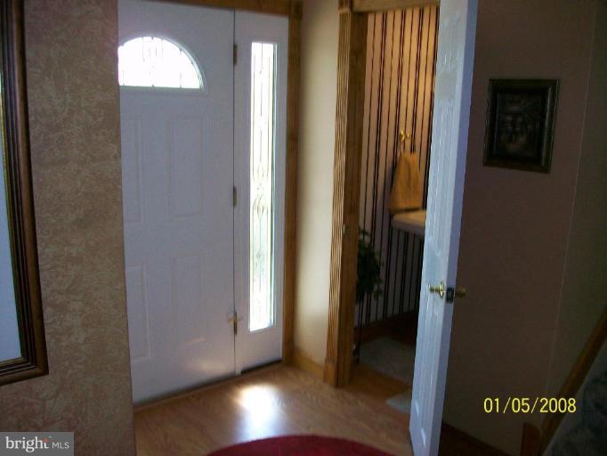 1202 Robin Court Halethorpe, MD 21227 - Photo 17 of 18 an empty room with wooden floor closet and windows