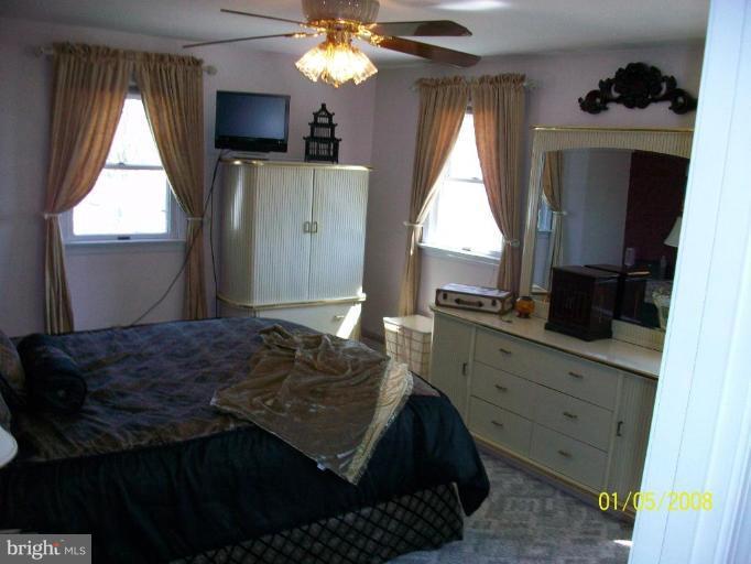 1202 Robin Court Halethorpe, MD 21227 - Photo 4 of 18 a bedroom with a bed window and a flat tv screen