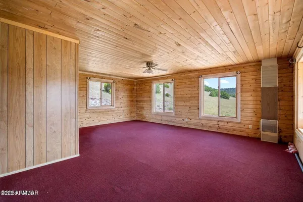 a living room with furniture a fireplace and a large window