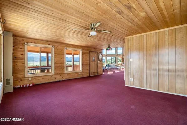 a bedroom with furniture and large windows