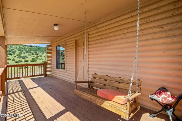 a view of a balcony with chair and wooden floor