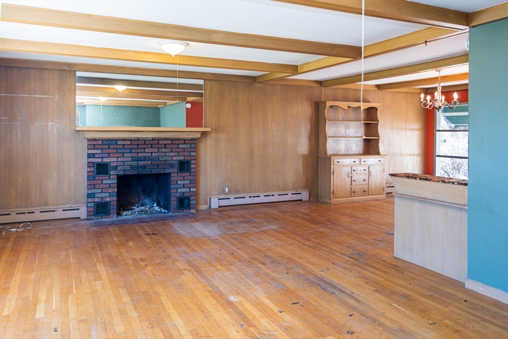 252 Thompson Road Webster, MA 01570 - Photo 16 of 39 a view of empty room with wooden floor and a fireplace