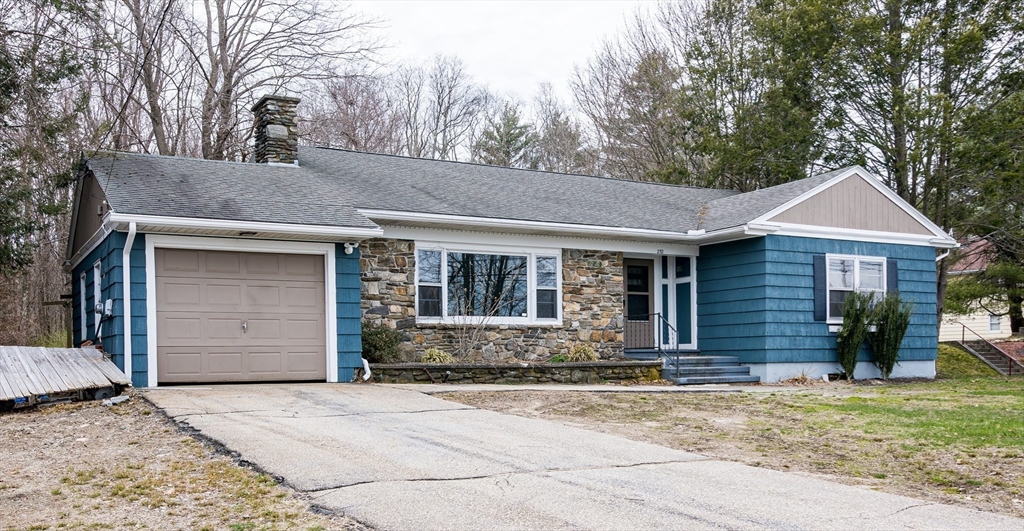 252 Thompson Road Webster, MA 01570 - Photo 17 of 39 a front view of a house with a yard and garage