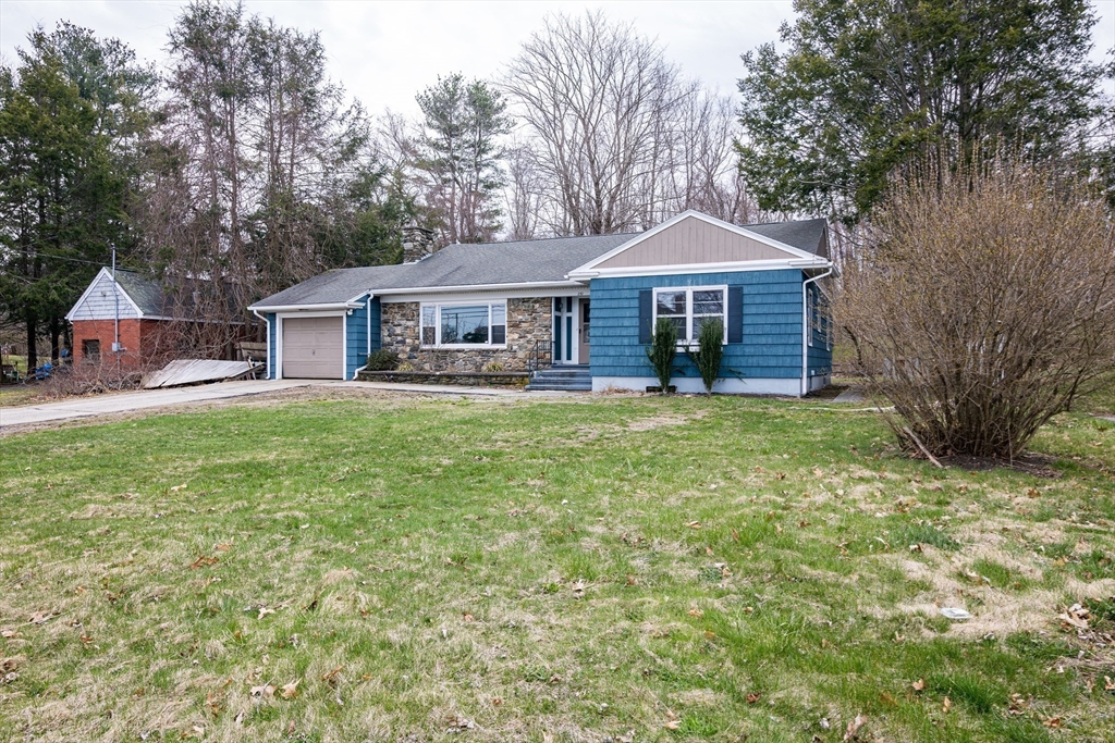 252 Thompson Road Webster, MA 01570 - Photo 18 of 39 front view of a house with a yard