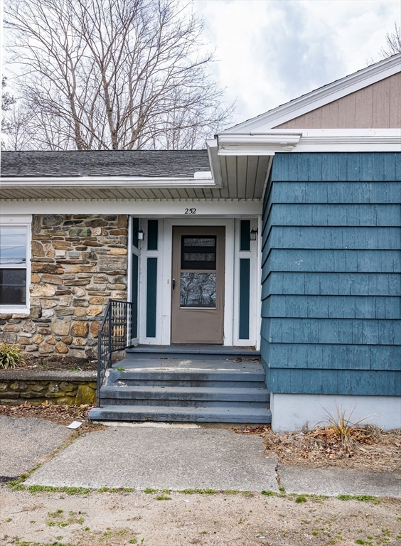 252 Thompson Road Webster, MA 01570 - Photo 19 of 39 a front view of a house with a yard
