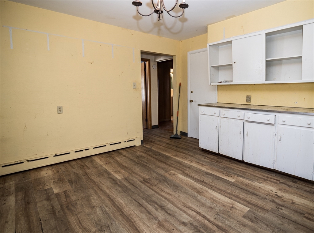 252 Thompson Road Webster, MA 01570 - Photo 25 of 39 a view of an empty room with a window and wooden floor