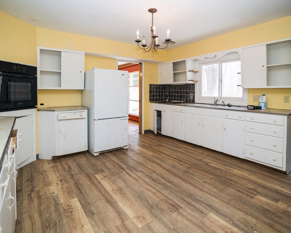 252 Thompson Road Webster, MA 01570 - Photo 26 of 39 a kitchen with a refrigerator and a stove top oven