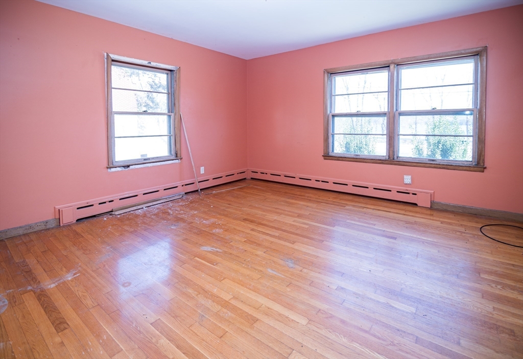 252 Thompson Road Webster, MA 01570 - Photo 29 of 39 an empty room with wooden floor and windows