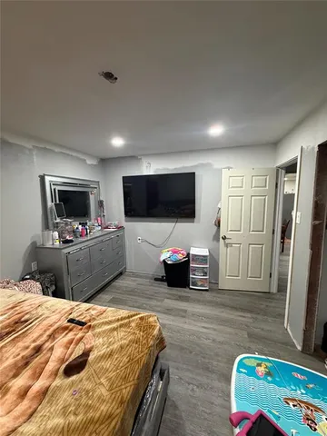 a bed room with a bed a television and a couch