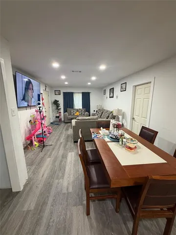 a view of a dining room with furniture and a window