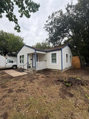 a front view of house with yard and trees