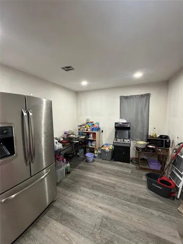 a view of a room with wooden floor and furniture