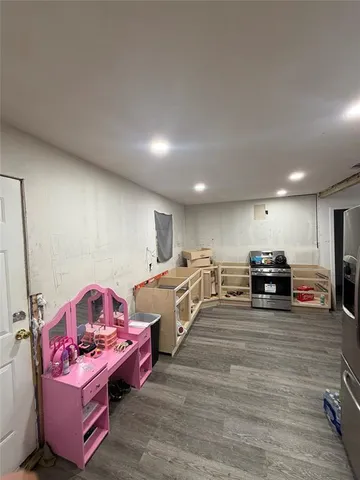 a living room with furniture a flat screen tv and gym equipment