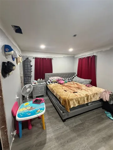 a bed sitting in a bedroom next to a window