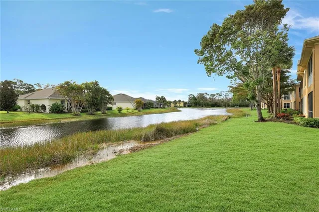 a view of a lake with houses in the back