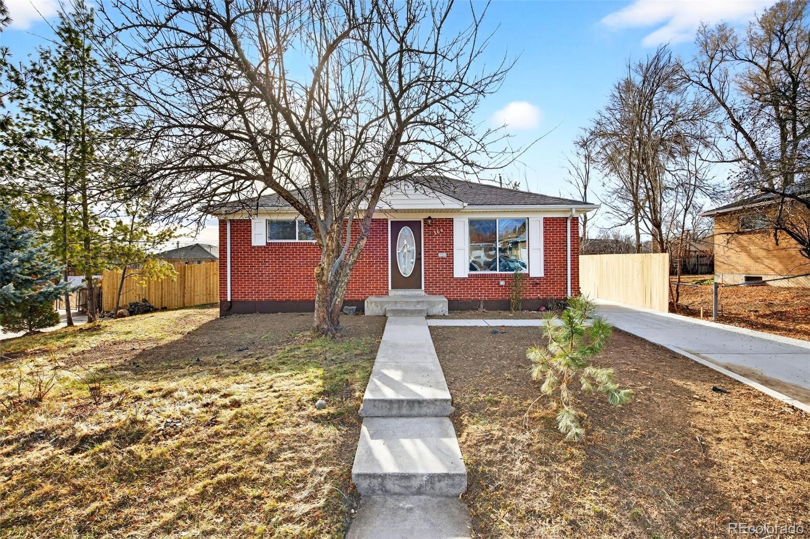 368 Emery Road Northglenn, CO 80233 - Photo 1 of 28 a front view of a house with a yard and trees