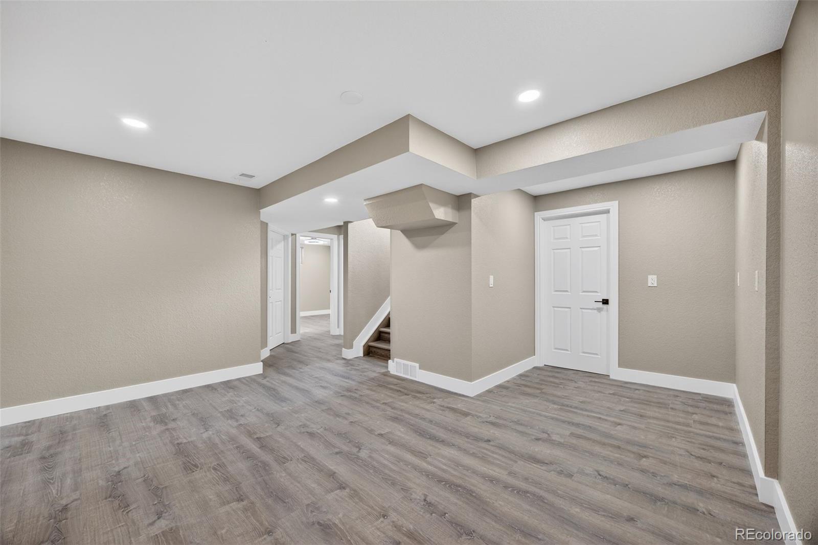 368 Emery Road Northglenn, CO 80233 - Photo 13 of 28 a view of an empty room with wooden floor