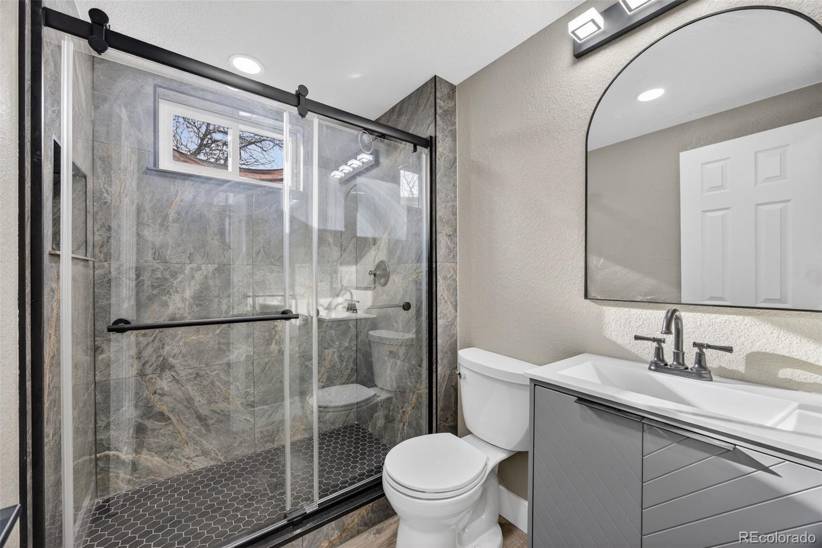 368 Emery Road Northglenn, CO 80233 - Photo 14 of 28 a bathroom with a sink toilet and shower