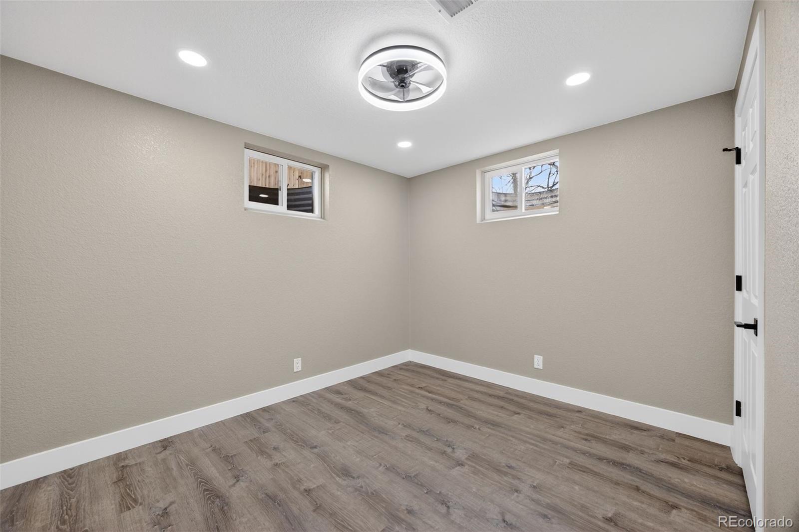 368 Emery Road Northglenn, CO 80233 - Photo 15 of 28 a view of an empty room with wooden floor