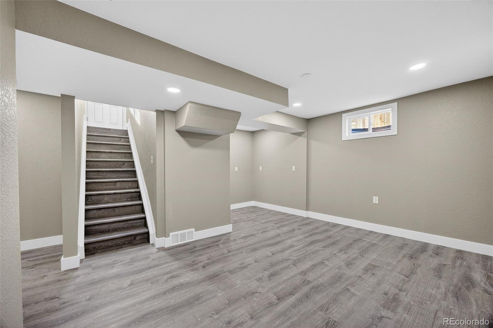 368 Emery Road Northglenn, CO 80233 - Photo 16 of 28 wooden floor in an empty room with stairs