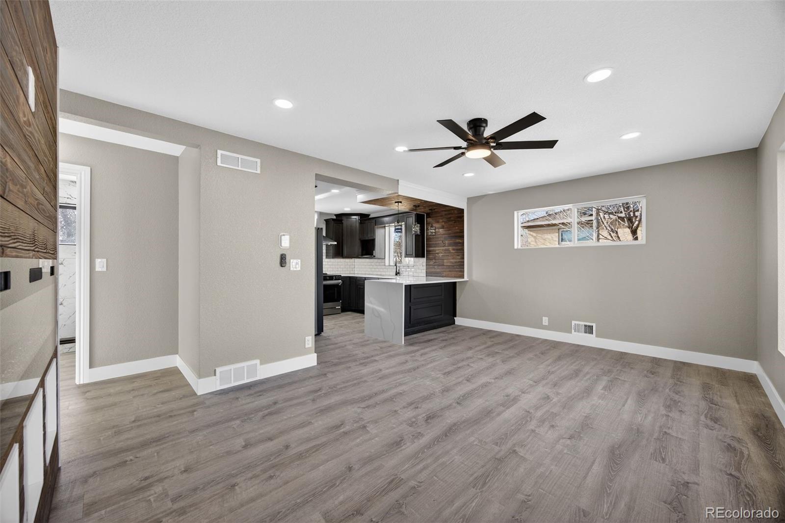 368 Emery Road Northglenn, CO 80233 - Photo 18 of 28 a view of a livingroom with a kitchen counter tops and wooden floor