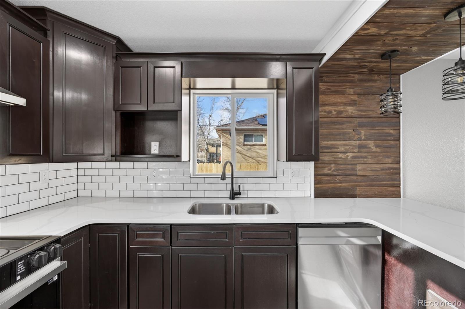 368 Emery Road Northglenn, CO 80233 - Photo 22 of 28 a kitchen with a sink and a window