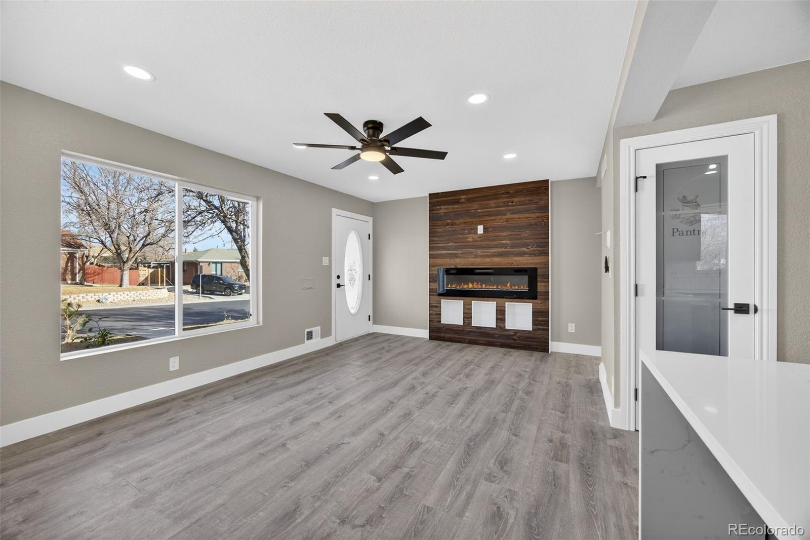 368 Emery Road Northglenn, CO 80233 - Photo 23 of 28 a view of an empty room with a window and wooden floor