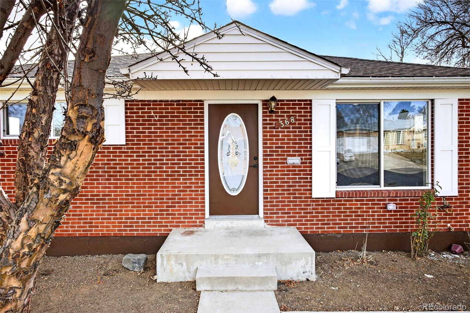 368 Emery Road Northglenn, CO 80233 - Photo 4 of 28 a front view of a house with a garden