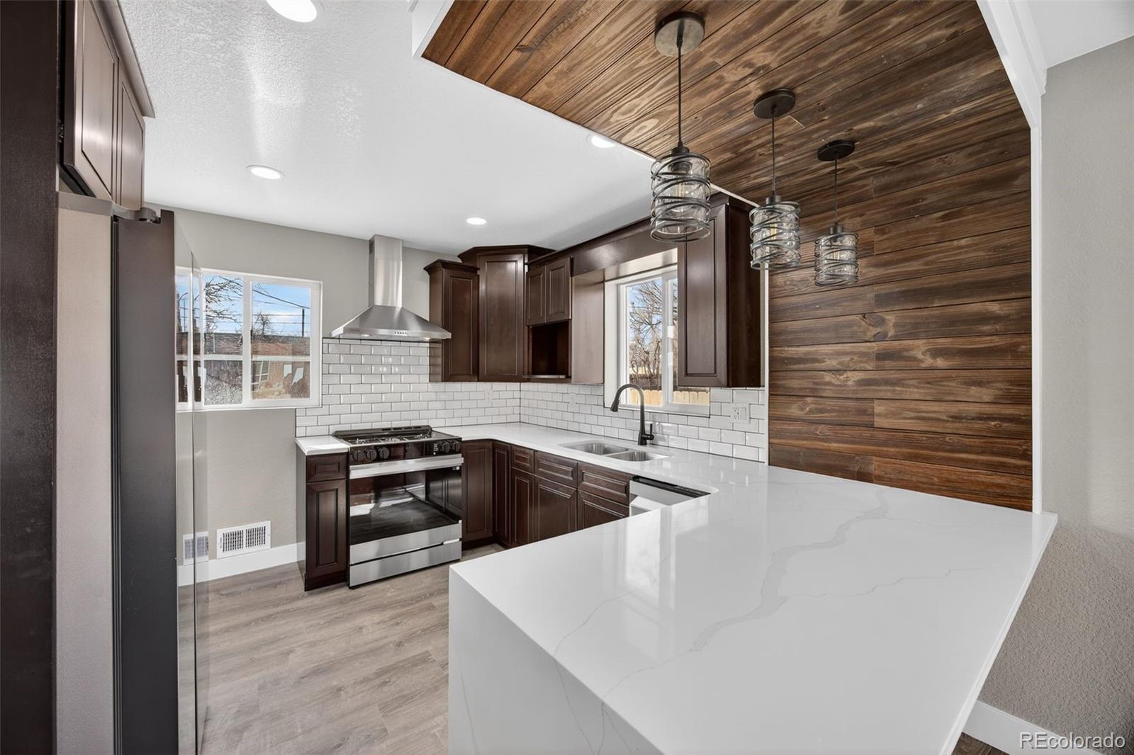 368 Emery Road Northglenn, CO 80233 - Photo 10 of 28 a kitchen with stainless steel appliances granite countertop a sink and a stove