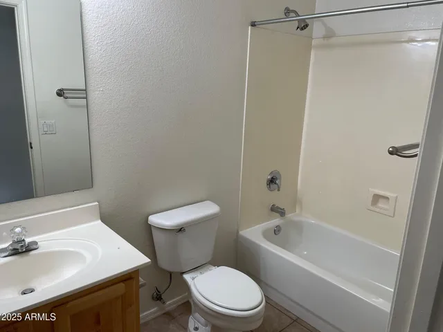 a white toilet sitting next to a bath tub