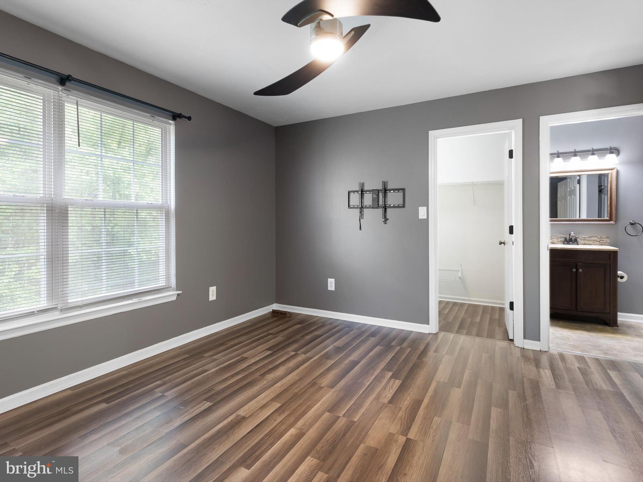 34 Dovetree Drive Newark, DE 19713 - Photo 12 of 29 a view of an empty room with a window and wooden floor