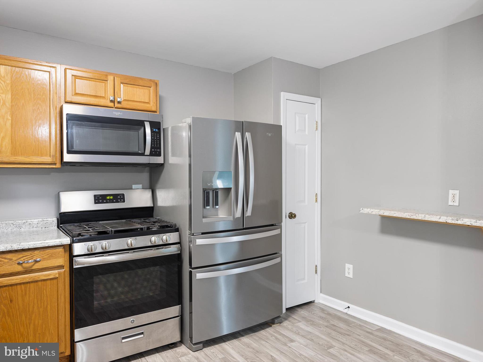 34 Dovetree Drive Newark, DE 19713 - Photo 20 of 29 a kitchen with granite countertop wooden cabinets stainless steel appliances and a window