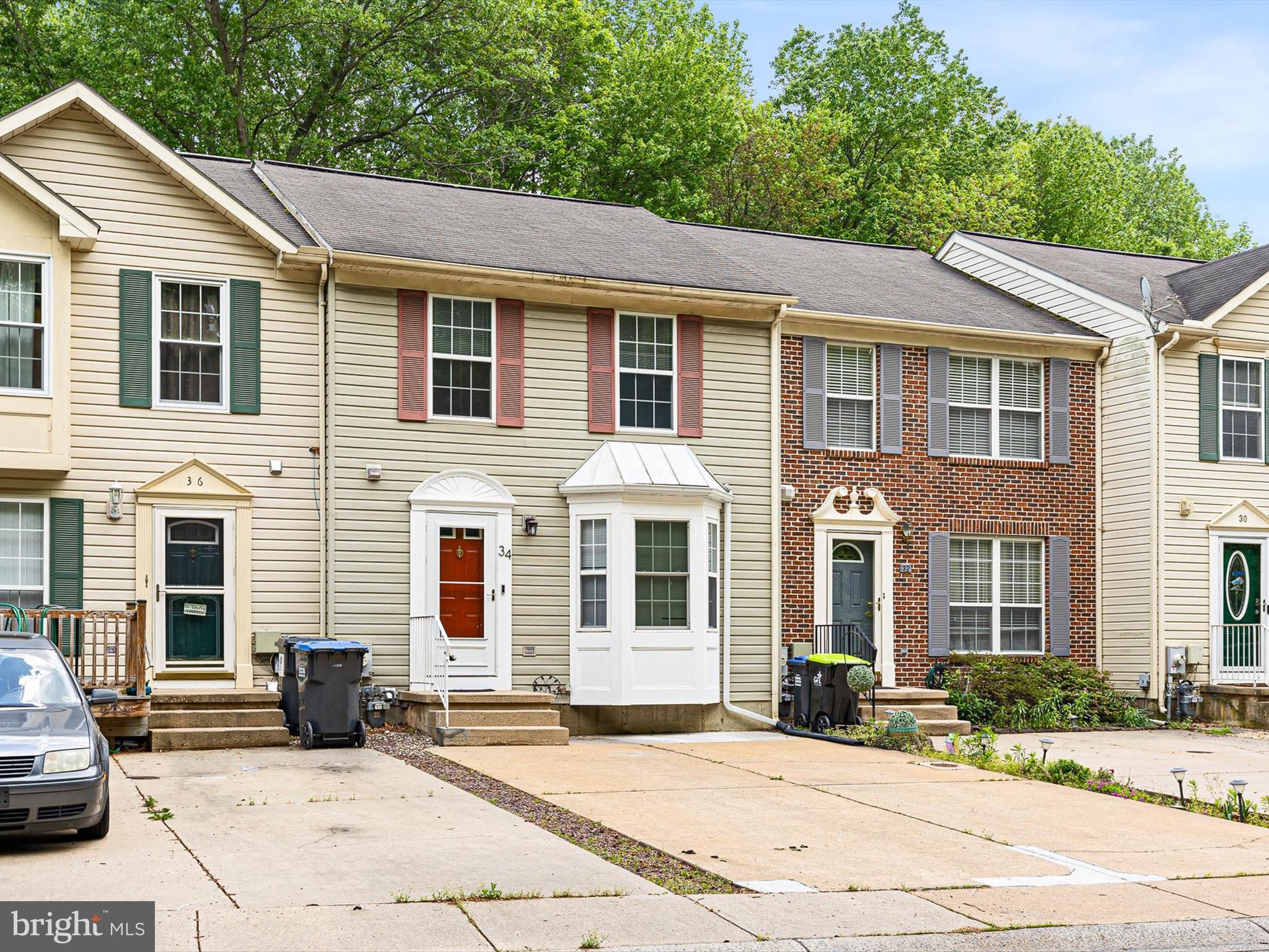 34 Dovetree Drive Newark, DE 19713 - Photo 2 of 29 a view of a white house with large windows next to a road