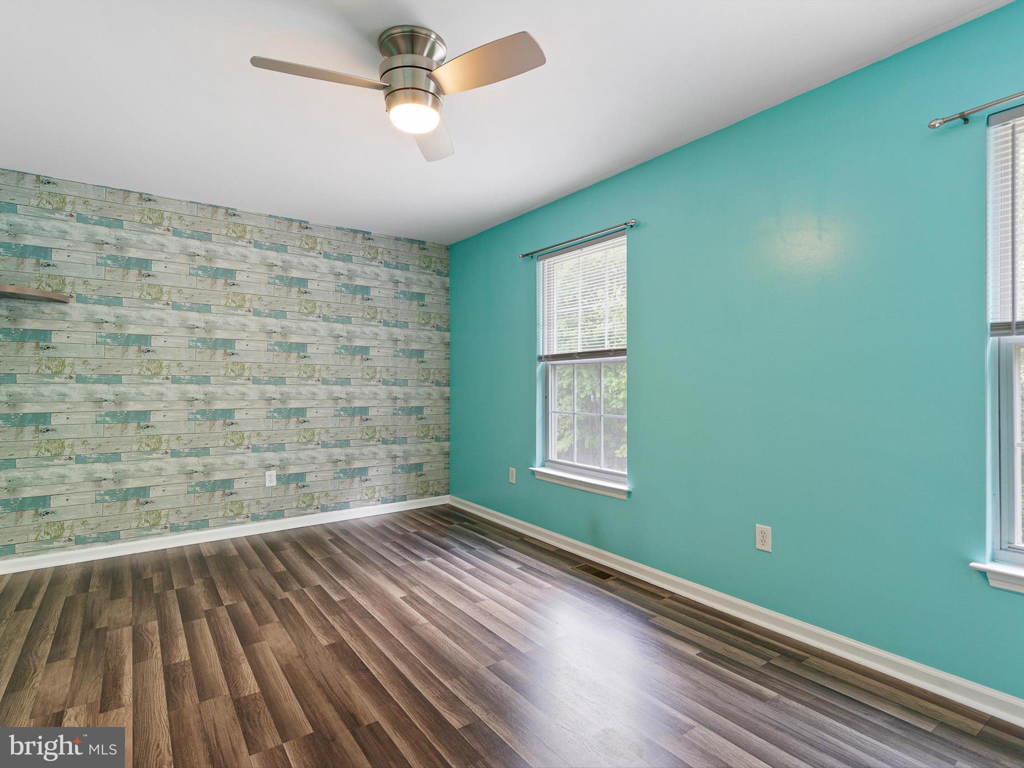 34 Dovetree Drive Newark, DE 19713 - Photo 9 of 29 a view of an empty room with a window and wooden floor