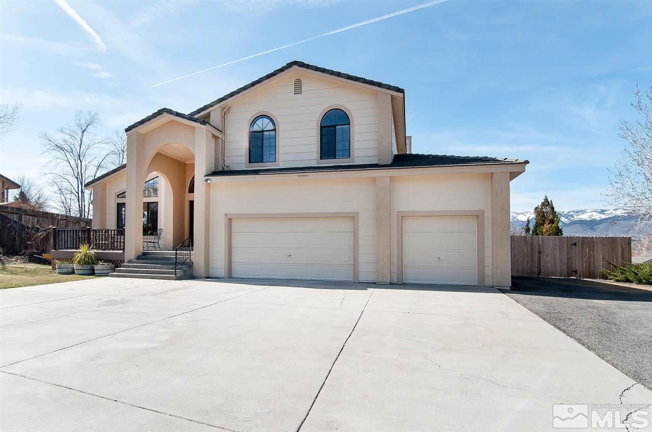 13330 Rim Rock Drive Reno, NV 89521 - Photo 1 of 1 a front view of a house with a yard and garage