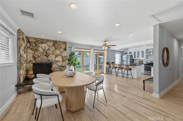 a living room with patio furniture and a potted plant