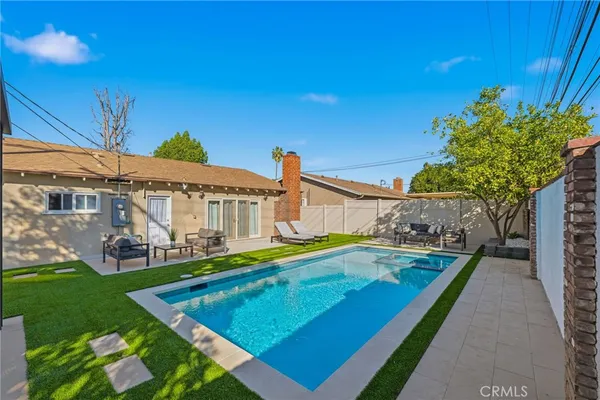 a view of a house with pool and chairs