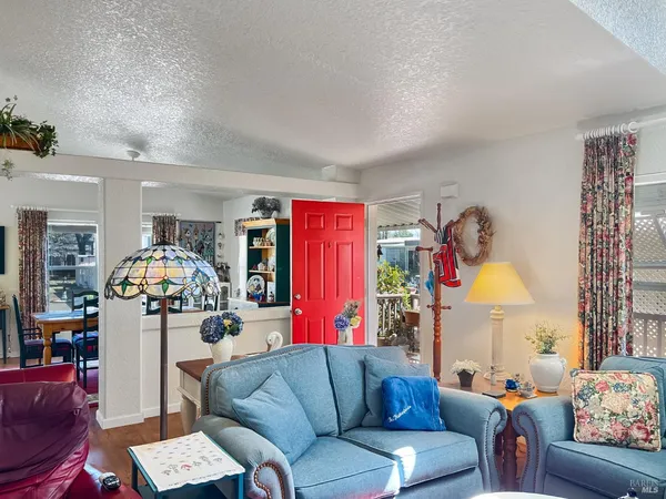 a living room with furniture and a chandelier