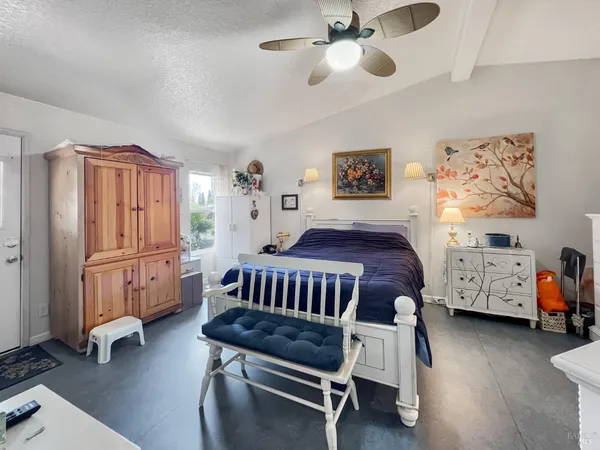 a bedroom with furniture and a window