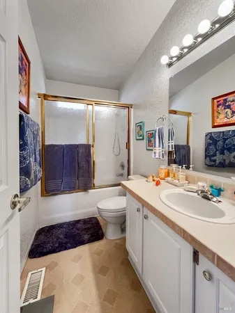 a bathroom with a tub a sink and mirror